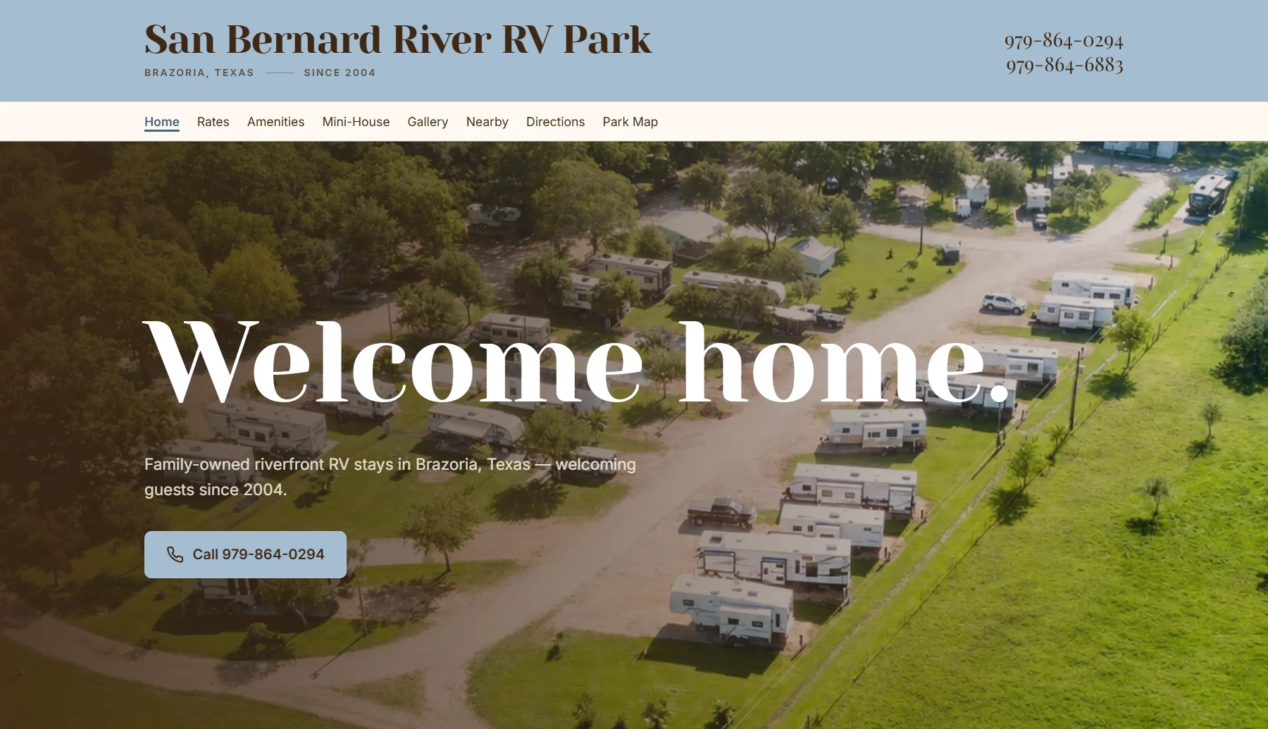 Homepage hero: aerial drone shot of the riverside RV park behind the 'Welcome home.' headline, with both phone numbers in the header and a call button.
